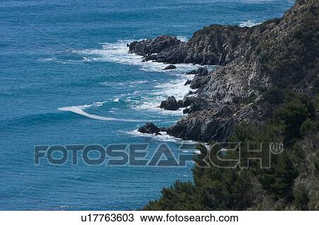 Aerial view of coastline with blue sea and surf against rocks View Large Photo Image Stock Image - Aerial view of coastline with blue sea and surf against rocks. Fotosearch