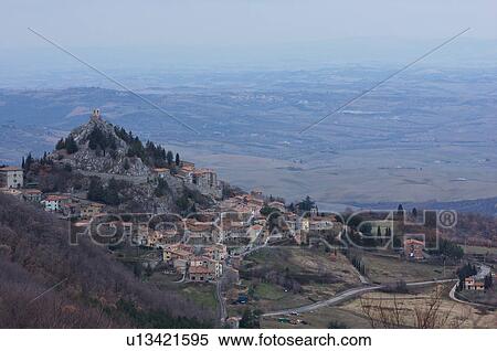 Aerial view of hill top town in Val d'Orcia, with plain beyond in afternoon winter mist View Large Photo Image Stock Photography - Aerial view of hill top town in Val d'Orcia, with plain beyond in afternoon winter mist. Fotosearch