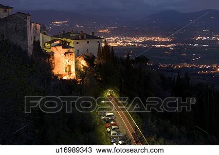 Aerial view of night landscape of mountains and valley, with hilltop town in foreground illuminated, and cars parked, with motion blur of brakelights along road, towns across valley View Large Photo Image Stock Image - Aerial view of night landscape of mountains and valley, with hilltop town in foreground illuminated, and cars parked, with motion blur of brakelights along road, towns across valley. Fotosearch
