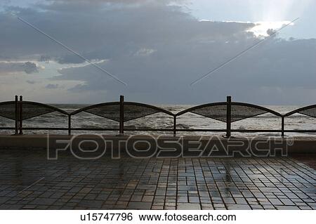 Stock Photograph - Agropoli, Campania, Southern Italy, sea front at dusk in storm. Fotosearch