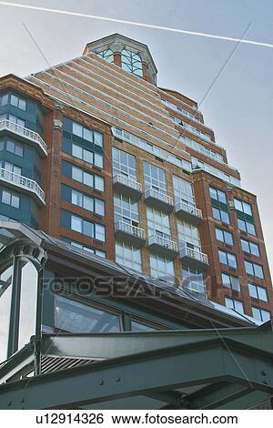 Stock Photograph - Apartment Buildings 72nd and Broadway, over 72 St. Subway station -view from sidewalk with contrail in blue sky. Fotosearch