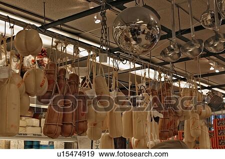 Assorted hanging cheeses for sale in New York delicatessen View Large Photo Image Stock Photo - Assorted hanging cheeses for sale in New York delicatessen. Fotosearch