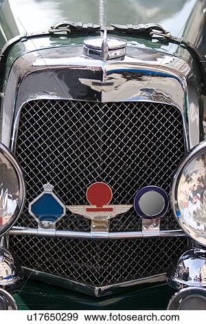 Stock Photo - Aston Martin, front view of mesh grille and headlamps. Fotosearch