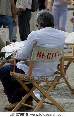 Back view of film Director sitting in directors chair, Italy View Large Photo Image Stock Photo - Back view of film Director sitting in directors chair, Italy. Fotosearch