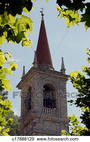Bell tower of church in Varenna, framed by trees View Large Photo Image Stock Photo - Bell tower of church in Varenna, framed by trees. Fotosearch