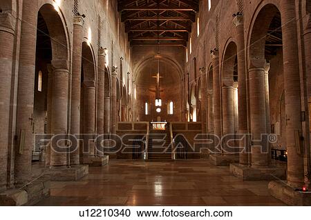 Stock Image - Benedictine Abbey of Nonantola, view of nave, elevated altar and apse, and stairs down to crypt. Fotosearch