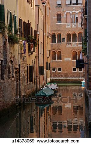 Stock Photo - boats and building reflections on canal. Fotosearch