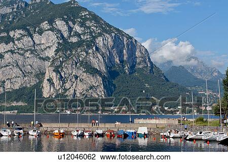 Boats in harbour, with mountains in background, Lake Como, Italy, View Large Photo Image Stock Image - Boats in harbour, with mountains in background, Lake Como, Italy,. Fotosearch