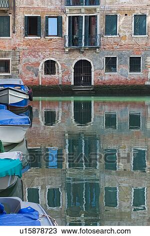 Boats moored along canal, with buildings reflected in water, View Large Photo Image Stock Image - Boats moored along canal, with buildings reflected in water, . Fotosearch