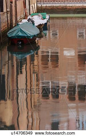 Stock Photo - boats moored and building reflections on canal. Fotosearch