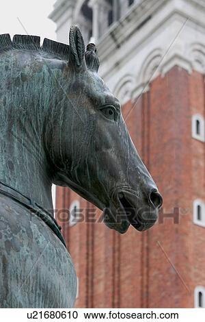 Bronze horses on front of Basilica San Marco (St Marks Basilica) with Campanile in background View Large Photo Image Stock Image - Bronze horses on front of Basilica San Marco (St Marks Basilica) with Campanile in background. Fotosearch