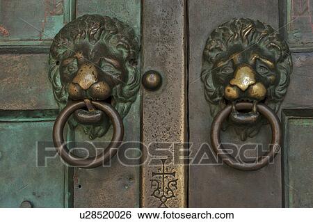 Stock Photograph - bronze lion head door knockers, Amalfi Duomo. Fotosearch