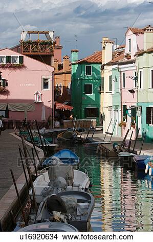 Burano canal with moored boats and reflections of brightly coloured buildings View Large Photo Image Picture - Burano canal with moored boats and reflections of brightly coloured buildings. Fotosearch