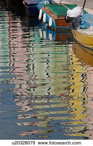Burano canal with moored boats and reflections of brightly coloured buildings View Large Photo Image Stock Photo - Burano canal with moored boats and reflections of brightly coloured buildings. Fotosearch