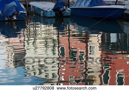 Burano canal with moored boats and reflections of brightly coloured buildings View Large Photo Image Stock Photo - Burano canal with moored boats and reflections of brightly coloured buildings. Fotosearch