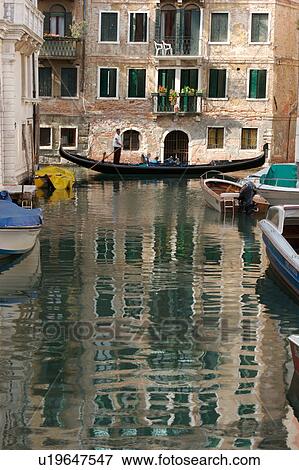 canal with gondola, boats moored and building reflection View Large Photo Image Stock Photo - canal with gondola, boats moored and building reflection. Fotosearch