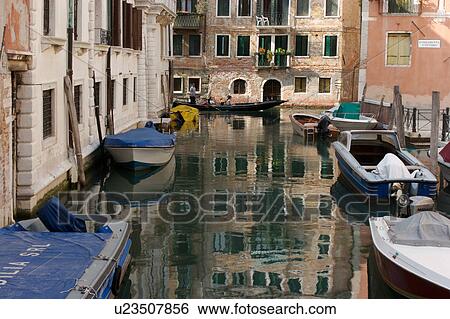 canal with gondola, boats moored and building reflection View Large Photo Image Stock Photograph - canal with gondola, boats moored and building reflection. Fotosearch