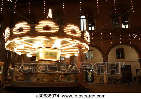 Carousel with horses in motion, Christmas lights in Ferrara View Large Photo Image Picture - Carousel with horses in motion, Christmas lights in Ferrara. Fotosearch