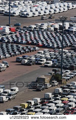 Stock Image - Cars and vans awaiting shipment on quayside. Fotosearch