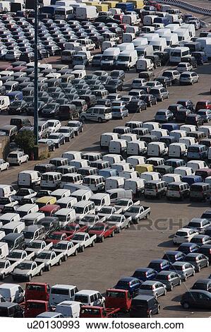 Stock Image - Cars and vans awaiting shipment on quayside. Fotosearch