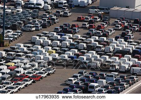 Stock Photography - Cars and vans awaiting shipment on quayside. Fotosearch