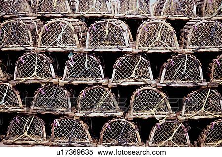 Close up of rows of stacked lobster traps, on sunny day View Large Photo Image Stock Photography - Close up of rows of stacked lobster traps, on sunny day. Fotosearch