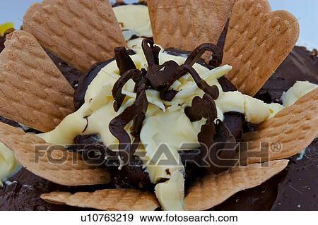 Stock Photo - Closeup of chocolate and cream pie, with triangular wafers around. Fotosearch