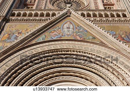 Stock Photo - Closeup of ornate decorative spiral stonework of arch and architrave over central doorway of Orvieto Duomo, with mosaics depicting Coronation of the Virgin and other Biblical scenes on each side. Fotosearch