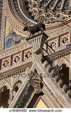 Closeup of trangular rchitrave over central doorway of Orvieto Duomo with bronze ram statue, part of Rose window and mosaic of Saint Augustus View Large Photo Image Stock Image - Closeup of trangular rchitrave over central doorway of Orvieto Duomo with bronze ram statue, part of Rose window and mosaic of Saint Augustus. Fotosearch