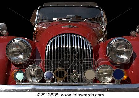 Stock Photography - Cut out front view of red Morgan showing hood, headlamps, and grille. Fotosearch