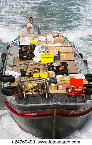 Stock Image - Delivery barge in motion, seen from above. Fotosearch