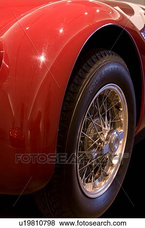 Stock Photo - Detail of antique red Ferrari, side rear view, showing wire spoked wheel. Fotosearch