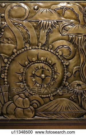 Stock Image - detail of Chanin building facade brass frieze. Fotosearch