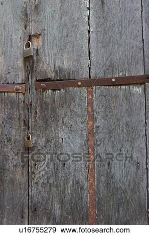Stock Photo - Detail of old Italian weathered wooden plank door. Fotosearch