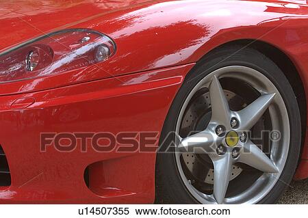 Detail of parked red Ferrari, front quarter view, on cloudy rainy day View Large Photo Image Stock Photography - Detail of parked red Ferrari, front quarter view, on cloudy rainy day. Fotosearch