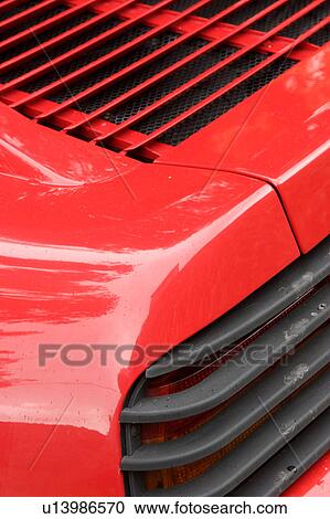 Detail of parked red Ferrari, rear and side view, on cloudy rainy day View Large Photo Image Stock Image - Detail of parked red Ferrari, rear and side view, on cloudy rainy day. Fotosearch