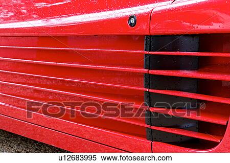 Detail of parked red Ferrari, side view, on cloudy rainy day View Large Photo Image Stock Photography - Detail of parked red Ferrari, side view, on cloudy rainy day. Fotosearch