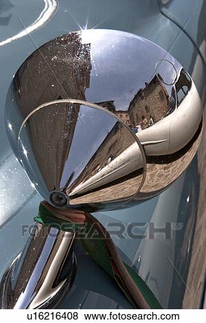 Detail of rear view wing mirror on antique car, with reflection of Italian piazza View Large Photo Image Stock Photo - Detail of rear view wing mirror on antique car, with reflection of Italian piazza. Fotosearch