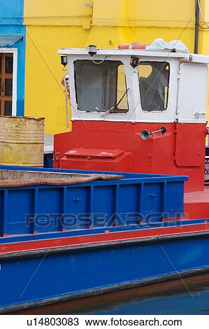 Detail of red and blue barge in Burano canal, with yellow building behind View Large Photo Image Stock Image - Detail of red and blue barge in Burano canal, with yellow building behind. Fotosearch
