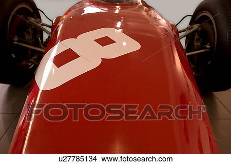 Picture - Detail of red Ferrari, race car, front view of hood and rear wheels, number 8 on hood. Fotosearch