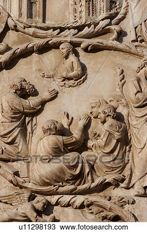 Stock Image - detail of stone sculptured bas-relief stone sculptured plaques on exterior facade of Orvieto Duomo, Umbria, Italy. Fotosearch