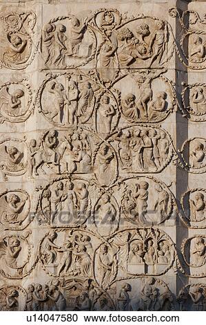 Stock Image - detail of stone sculptured bas-relief stone sculptured plaque, showing new Testament scenes, on exterior facade of Orvieto Duomo, Umbria, Italy. Fotosearch