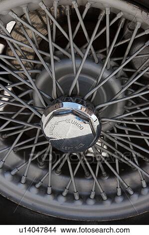 Detail of wire spoked wheel with chrome knock off hub View Large Photo Image Picture - Detail of wire spoked wheel with chrome knock off hub. Fotosearch