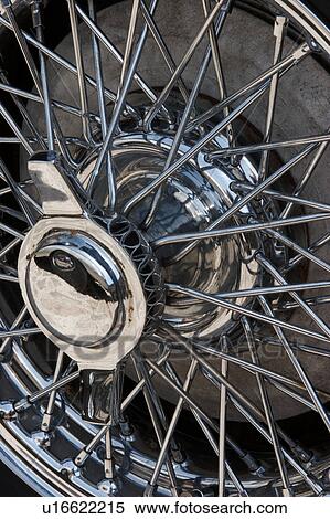 Detail of wire spoked wheel with chrome knock off hub View Large Photo Image Stock Photography - Detail of wire spoked wheel with chrome knock off hub. Fotosearch