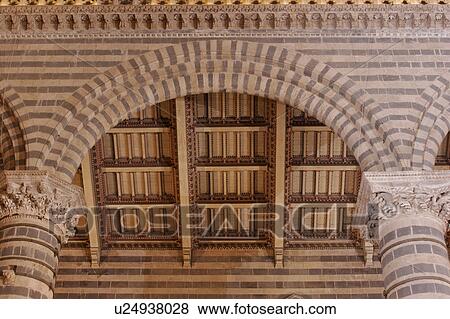 Stock Photo - Detail view of side nave of Orvieto Duomo, showing black and white striped columns, arches, wooden sloped ceiling. Fotosearch