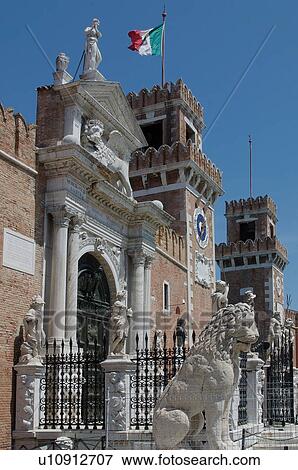 Stock Photo - Entrance to Arsenale with lion statue and fortified walls. Fotosearch