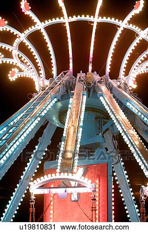 Stock Image - Fairground carousel wheels at night, illuminated, in motion, Gatineau, Quebec, Canada. Fotosearch