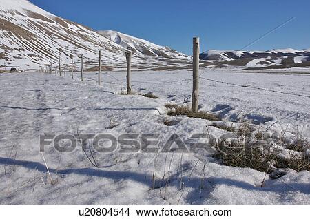 fenced fields and mountain background on snowy winter day, with bright sunshine and blue sky View Large Photo Image Picture - fenced fields and mountain background on snowy winter day, with bright sunshine and blue sky. Fotosearch