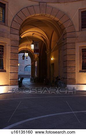 Ferrara Theatre inner courtyard, illuminated circular building, with parked bicycles, Castello Estense in background View Large Photo Image Stock Image - Ferrara Theatre inner courtyard, illuminated circular building, with parked bicycles, Castello Estense in background. Fotosearch