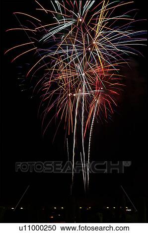 Fireworks exploding in the black night sky with town lights below View Large Photo Image Stock Image - Fireworks exploding in the black night sky with town lights below. Fotosearch